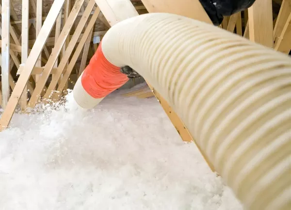Blown-in attic insulation installation improving energy efficiency and indoor comfort in homes